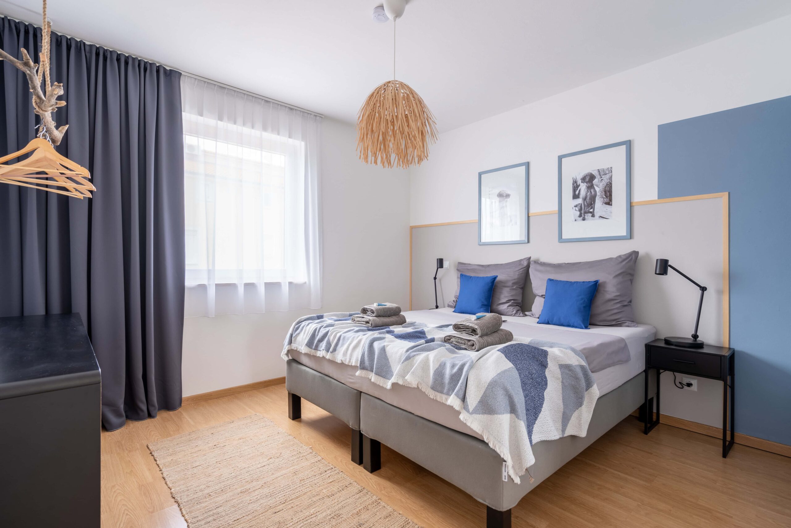 Bedroom with framed dog photography and blue accent wall in Medulin, Istria